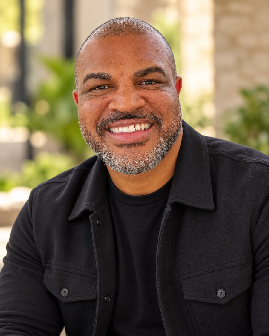 Portrait of author BJ Johnson smiling, wearing a black jacket outdoors.